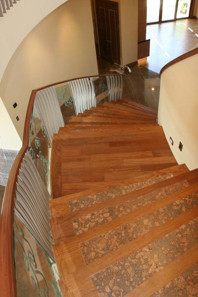 Photo of a modern wood curved staircase in Las Vegas with wood risers.