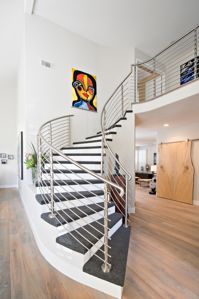 This is an example of a medium sized contemporary curved metal railing staircase in Los Angeles.