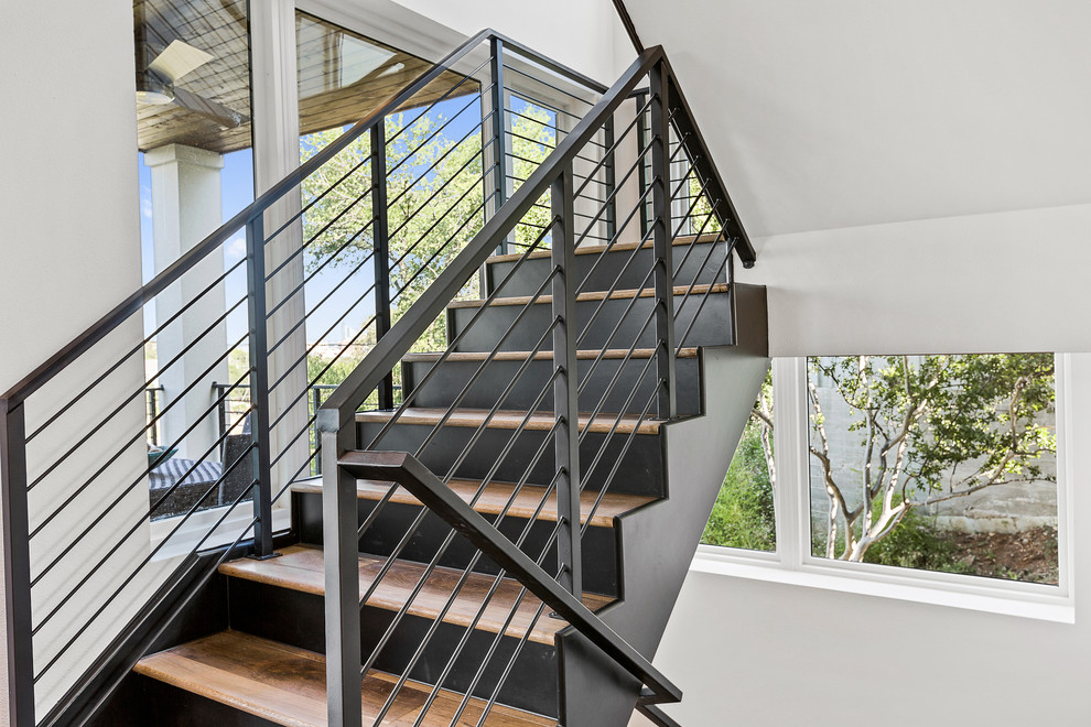 Inspiration for a modern wooden metal railing staircase remodel in Austin with painted risers