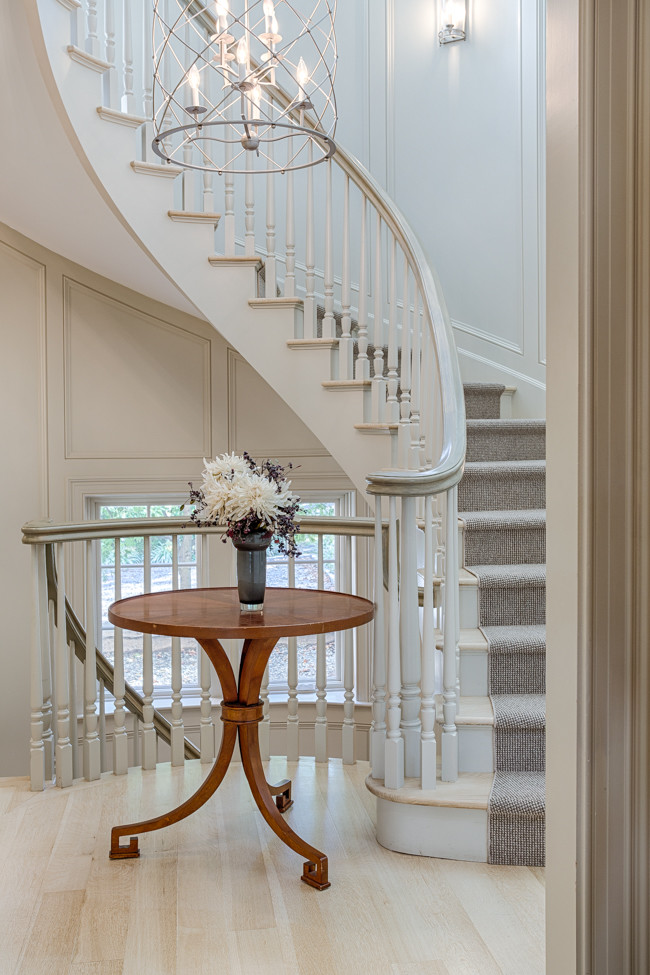 Inspiration for a mid-sized timeless wooden curved staircase remodel in New York with painted risers