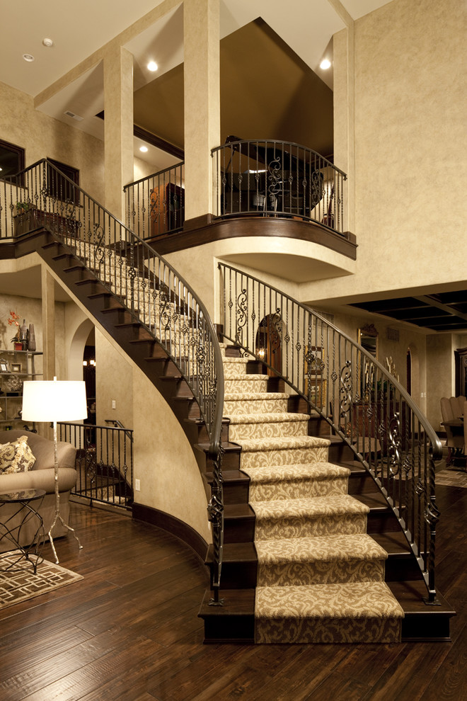 Inspiration for a traditional wood curved staircase in Indianapolis with wood risers and feature lighting.