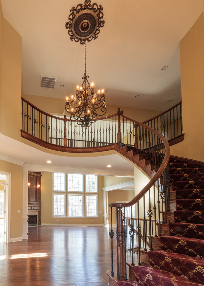 Inspiration for a large traditional wood curved staircase in Charlotte.
