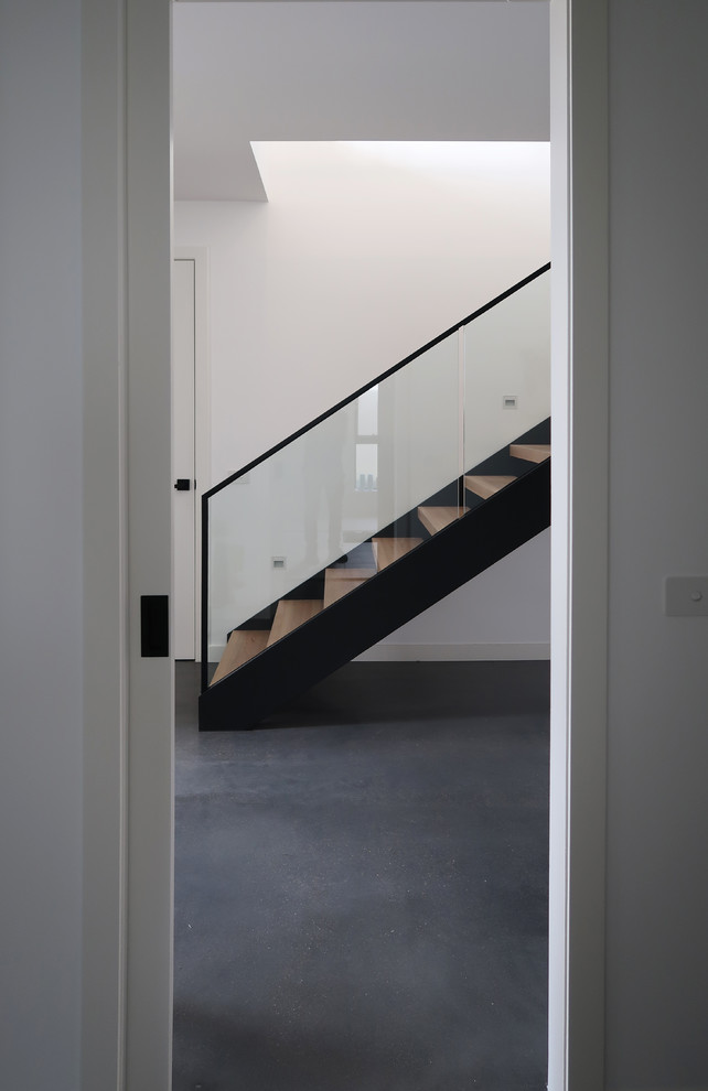 Photo of a medium sized contemporary wood l-shaped metal railing staircase in Melbourne with open risers.