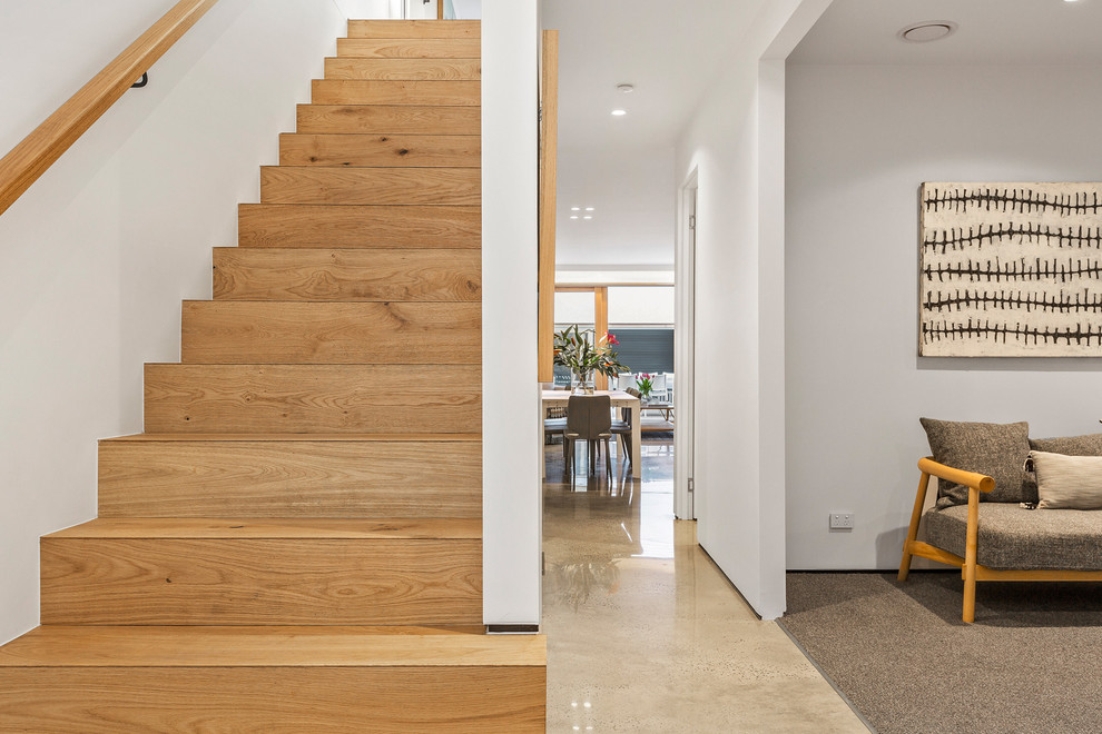 Staircase - mid-sized contemporary wooden straight wood railing staircase idea in Melbourne with wooden risers