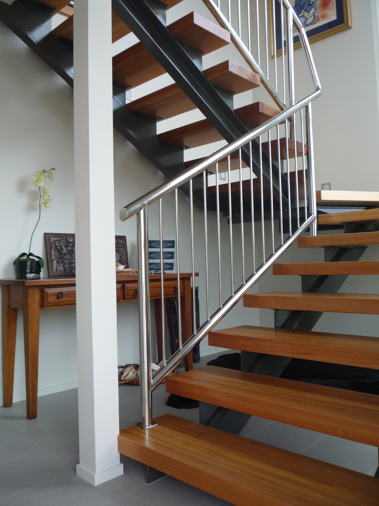 Ejemplo de escalera suspendida urbana de tamaño medio sin contrahuella con escalones de madera