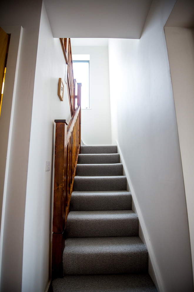 Traditional carpeted u-shaped wood railing staircase in Cork.