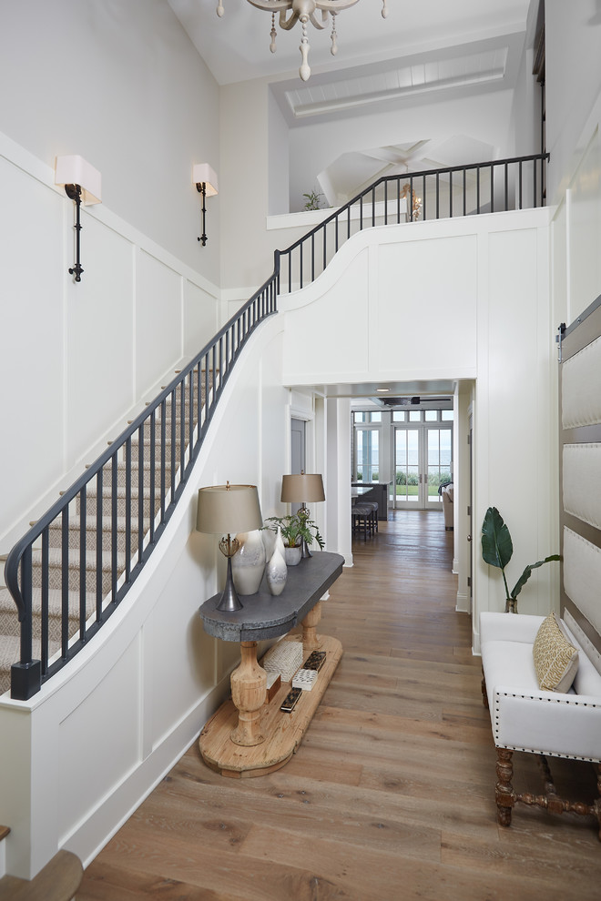 Inspiration for a large coastal carpeted l-shaped staircase remodel in Grand Rapids with carpeted risers