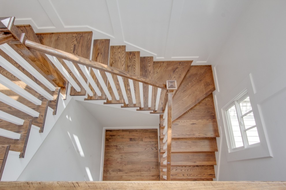 Inspiration for a large timeless wooden straight wood railing staircase remodel in Houston