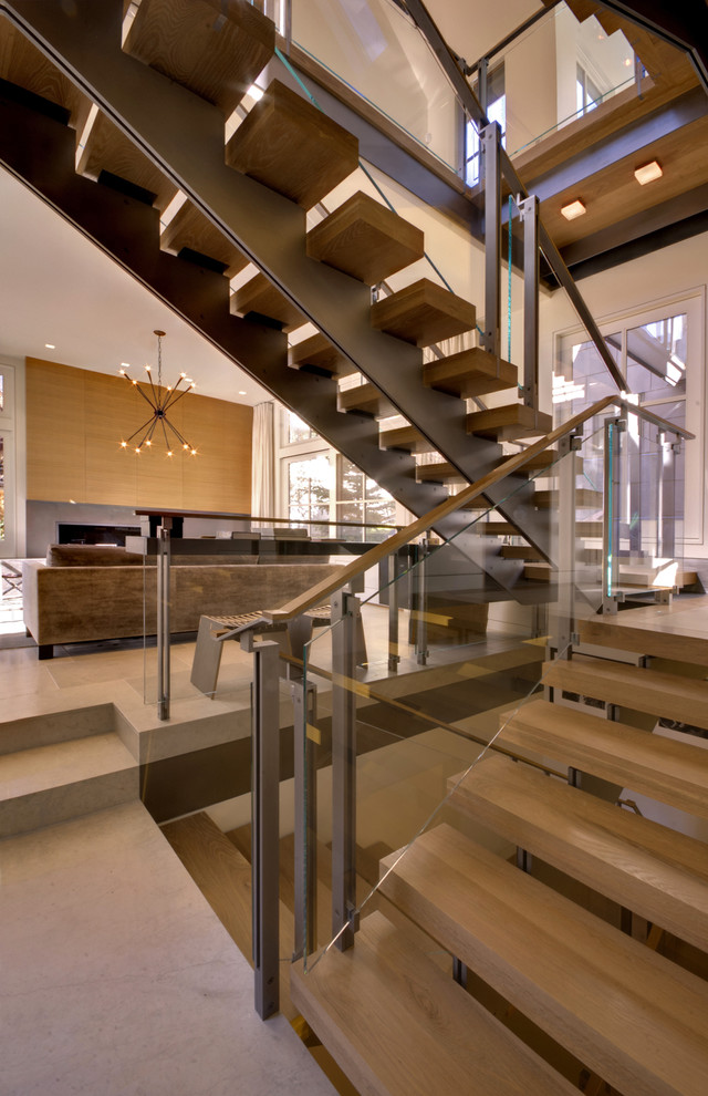Example of a trendy open and glass railing staircase design in Denver
