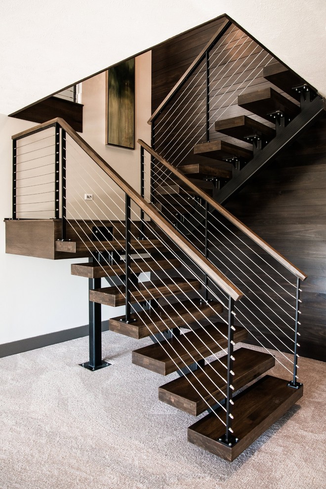 This is an example of a large classic wood u-shaped staircase in Orange County with open risers.
