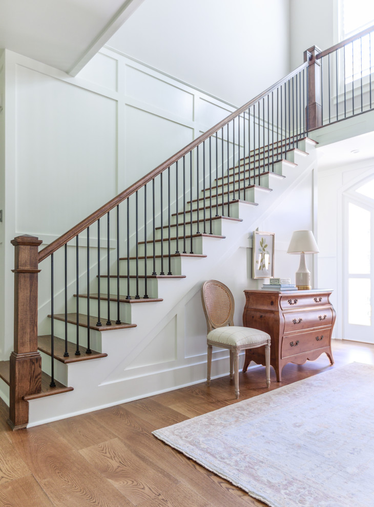 Photo of a rural wood u-shaped mixed railing staircase in Jacksonville with painted wood risers and feature lighting.