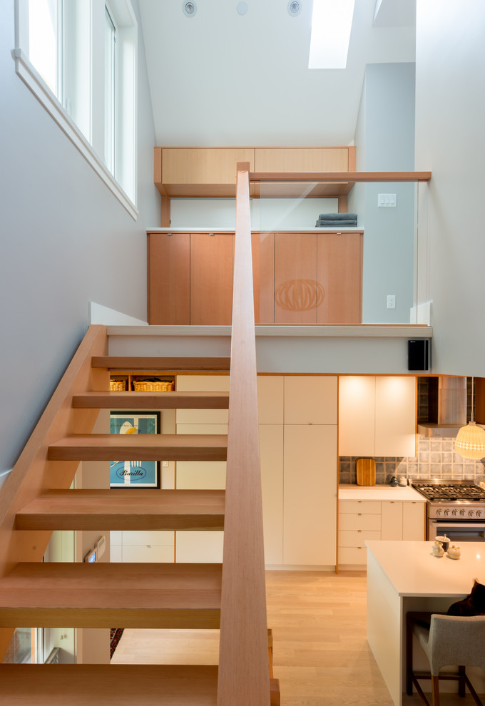 This is an example of a contemporary floating staircase in Vancouver with open risers.