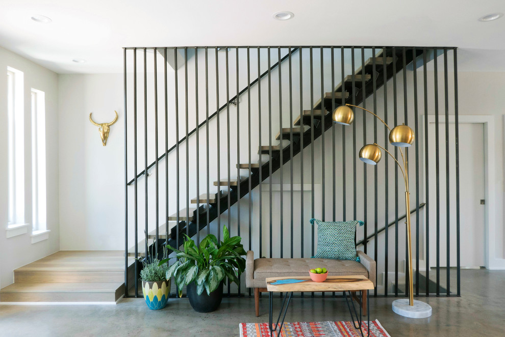 Design ideas for a medium sized midcentury wood straight staircase in Austin with open risers and feature lighting.