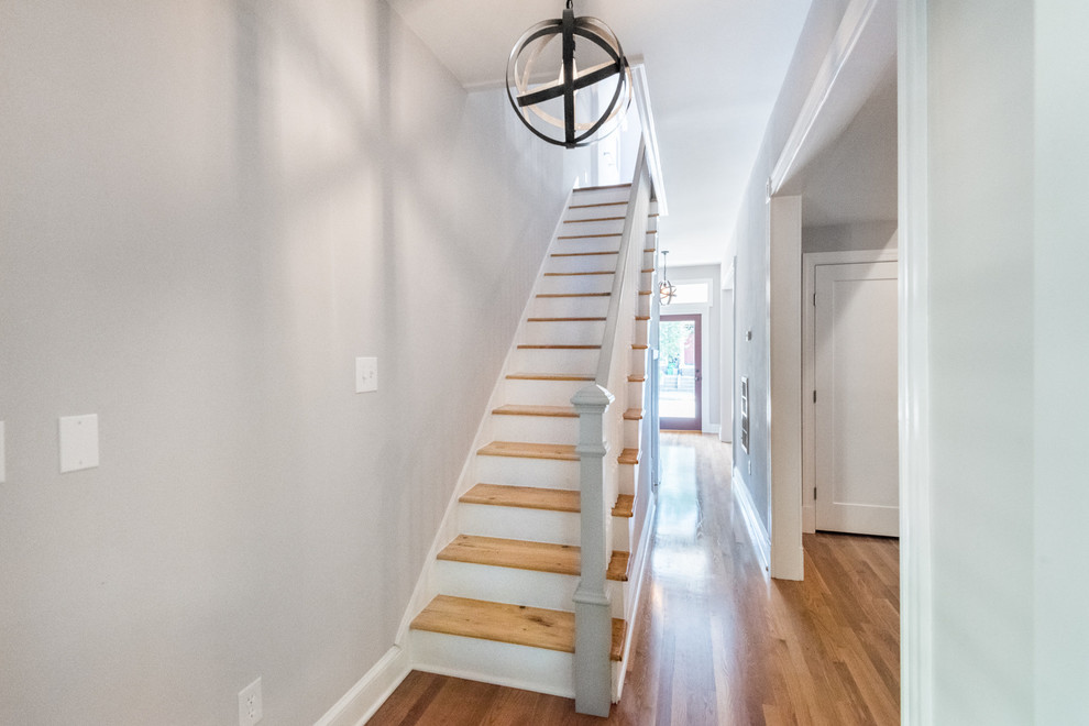 Inspiration for a medium sized modern wood straight staircase in Wilmington with painted wood risers.