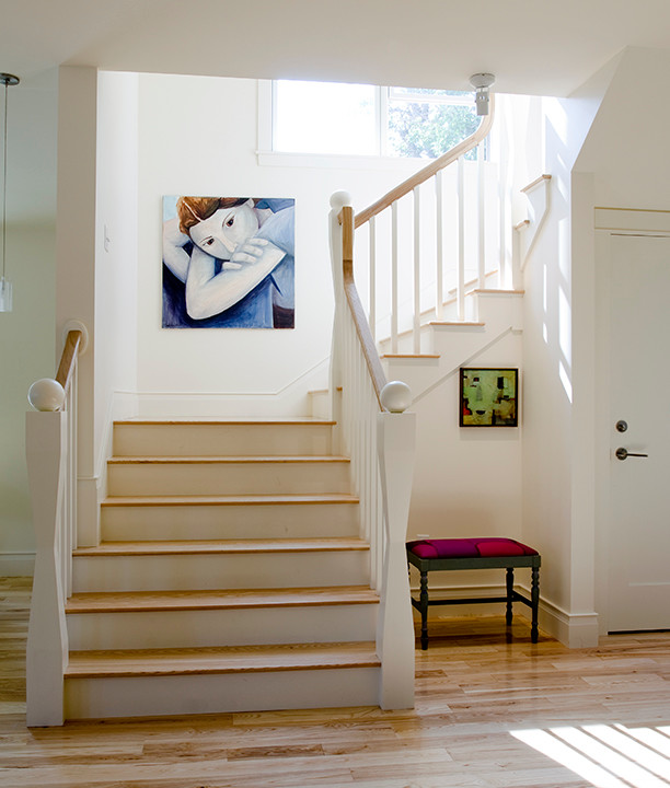 Staircase - mid-sized transitional wooden u-shaped staircase idea in Portland Maine with wooden risers