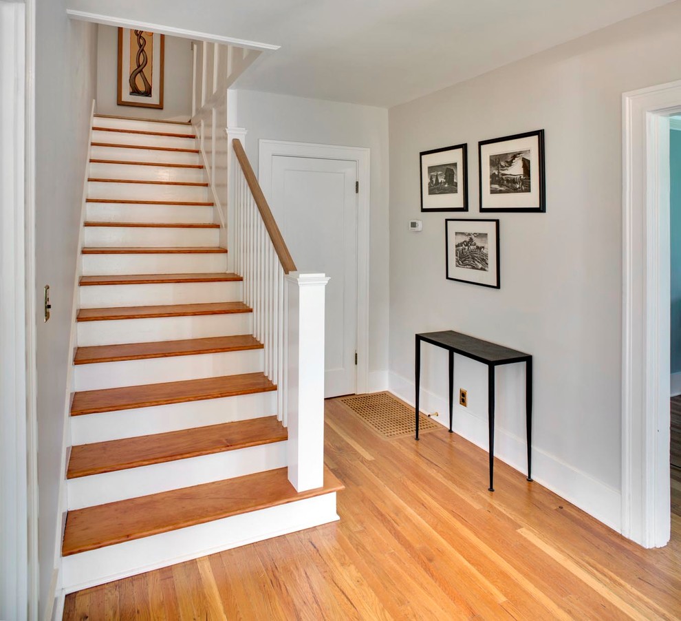 Inspiration for a medium sized traditional wood straight staircase in Portland with painted wood risers.