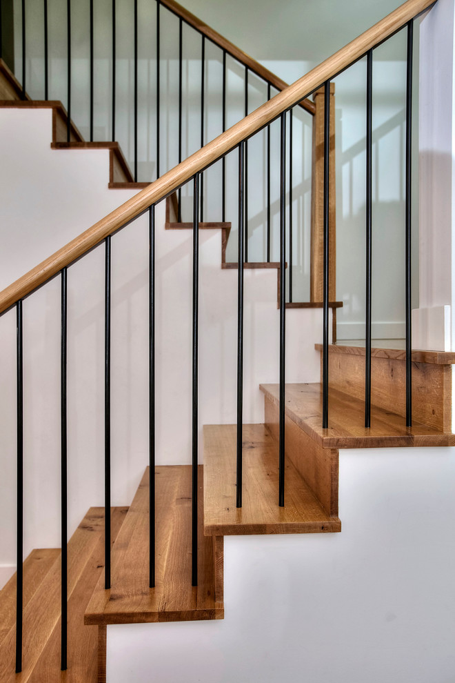 Imagen de escalera campestre de tamaño medio con escalones de madera, contrahuellas de madera y barandilla de madera