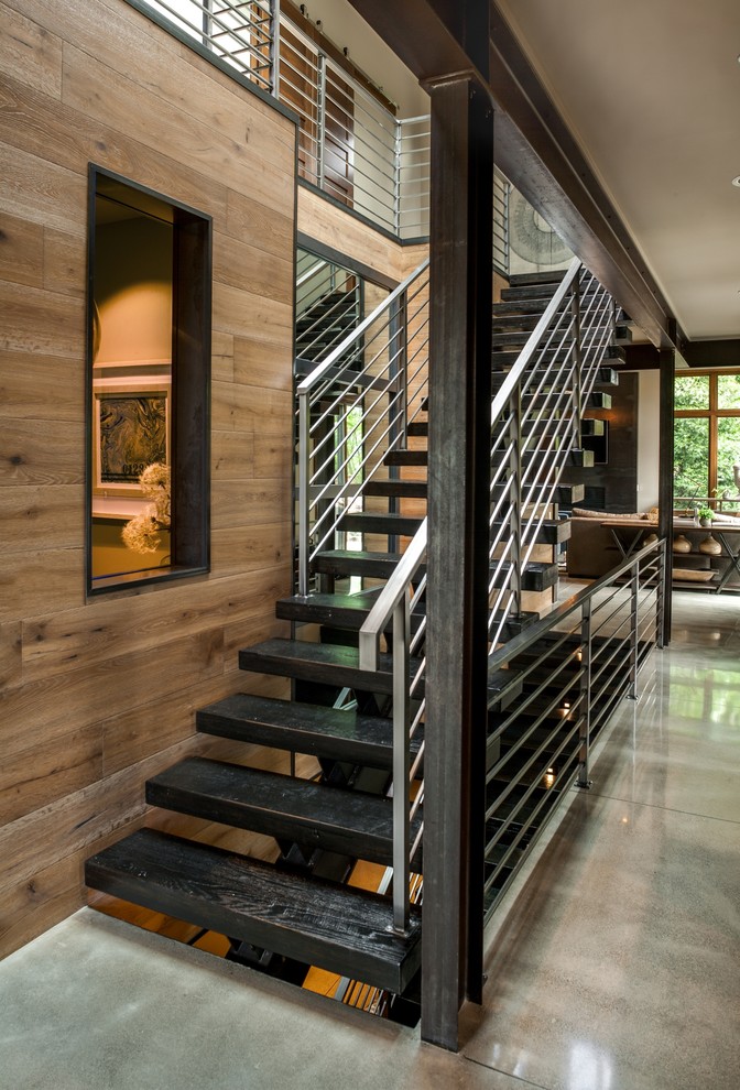Large contemporary wood straight metal railing staircase in Seattle with open risers.