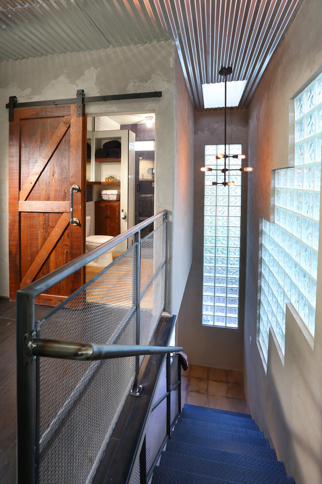 Inspiration for a large industrial metal straight staircase remodel in Los Angeles with metal risers