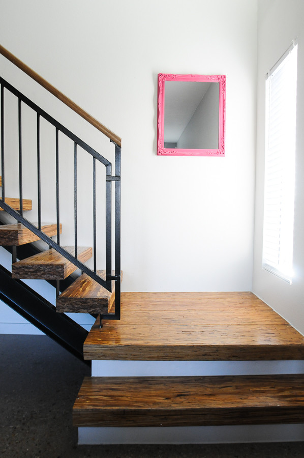 Small contemporary wood straight staircase in Austin with open risers.