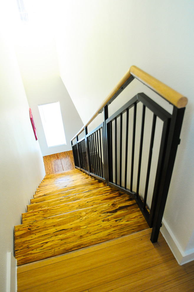 Photo of a small contemporary wood straight staircase in Austin with open risers.