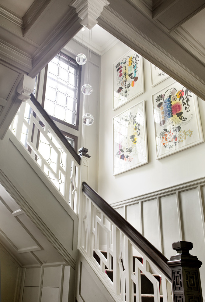 Example of a classic wood railing staircase design in Boston