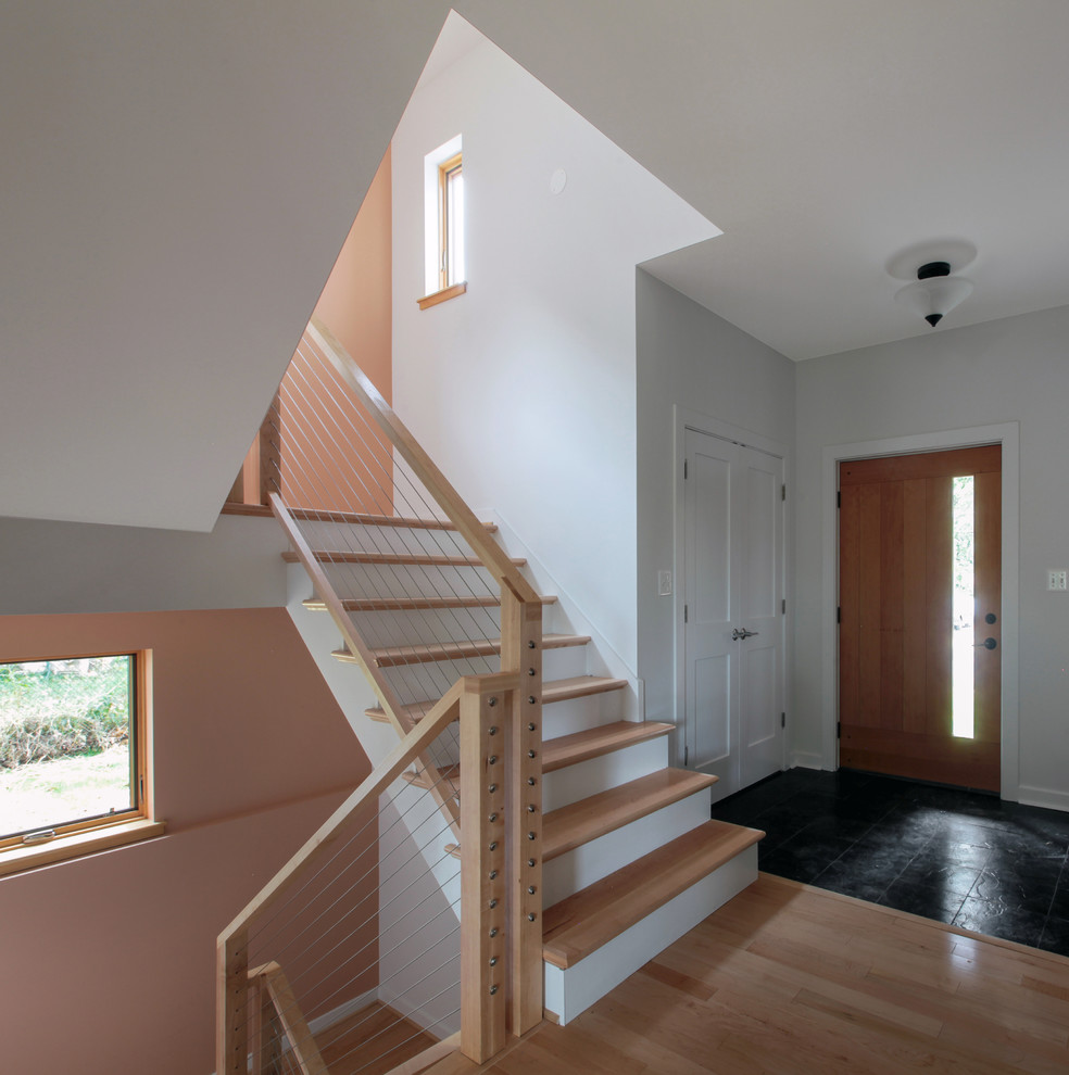 Inspiration for a mid-sized modern wooden u-shaped staircase remodel in DC Metro with painted risers