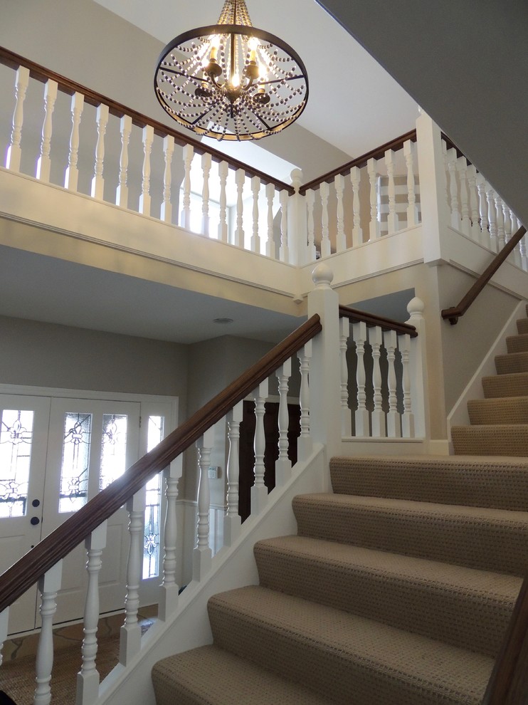 Staircase - traditional carpeted straight wood railing staircase idea in Minneapolis with concrete risers