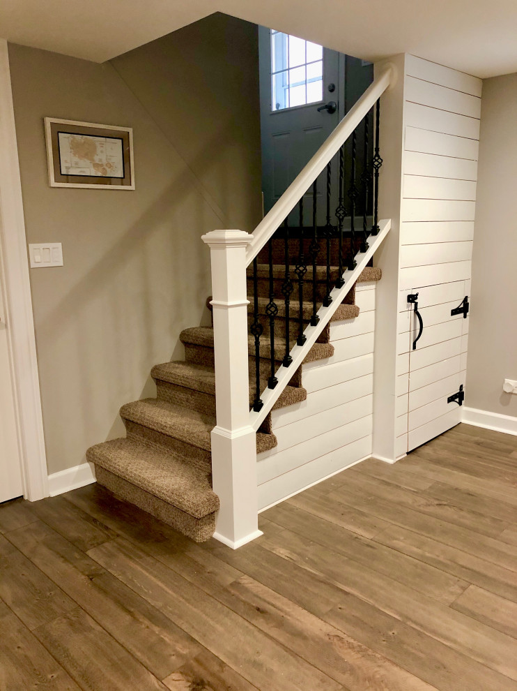 Design ideas for a small classic concrete straight mixed railing staircase in Chicago with carpeted risers and tongue and groove walls.