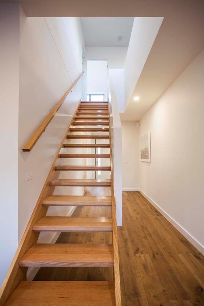 Beach style wood straight wood railing staircase in Melbourne with open risers.