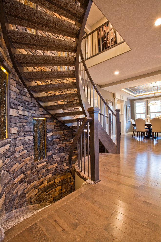 Transitional carpeted curved open staircase photo in Calgary