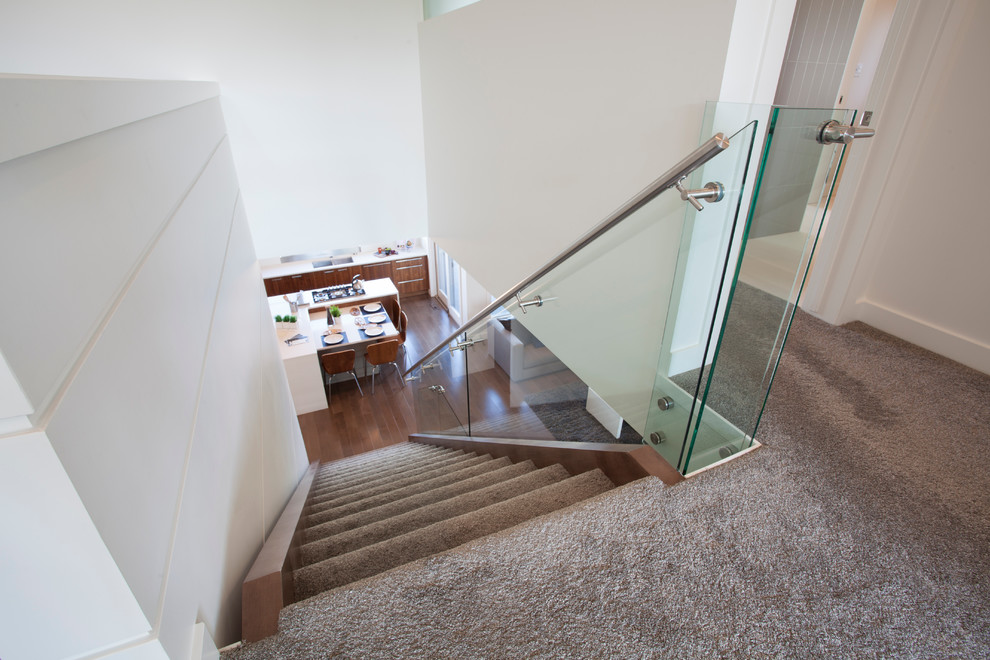 Small modern carpeted straight staircase in Calgary with open risers.