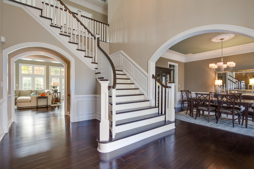 Photo of a large traditional wood l-shaped staircase in Baltimore with wood risers.