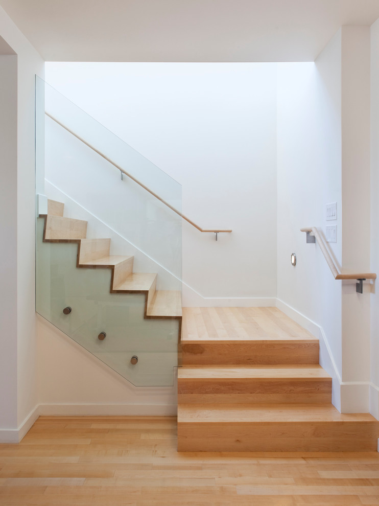 Inspiration for a modern wooden wood railing staircase remodel in San Francisco with wooden risers