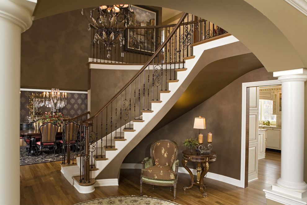Photo of a contemporary wood curved staircase in Minneapolis.