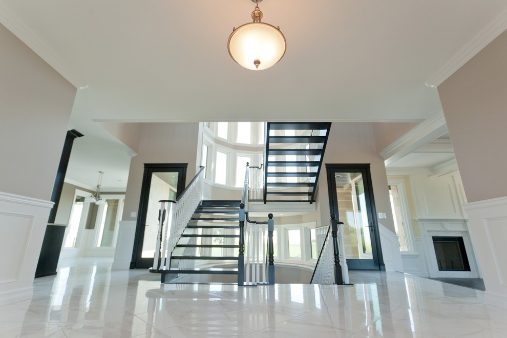 Example of a large classic u-shaped open staircase design in Calgary