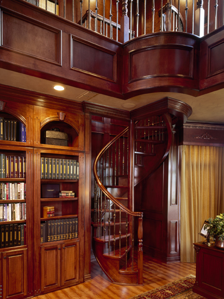 Large traditional wood spiral staircase in Dallas with wood risers.