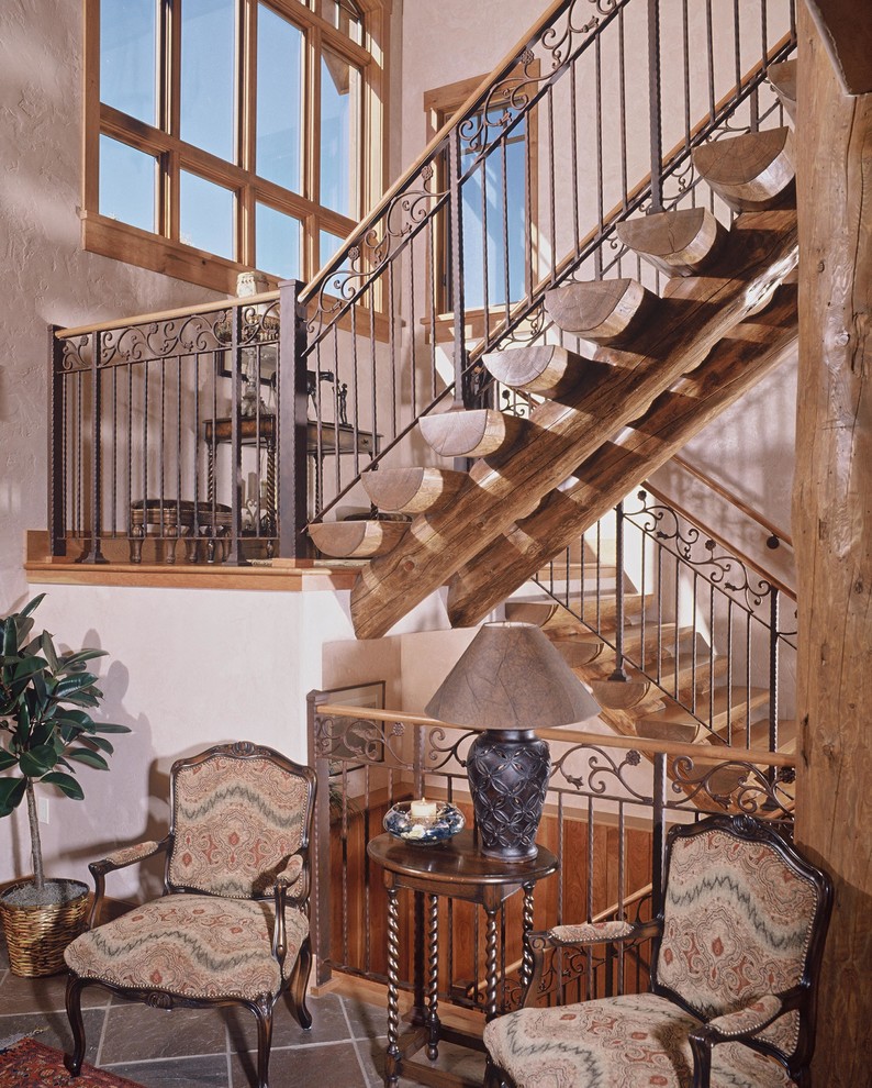Design ideas for a large rustic wood l-shaped metal railing staircase in Denver with wood risers and feature lighting.