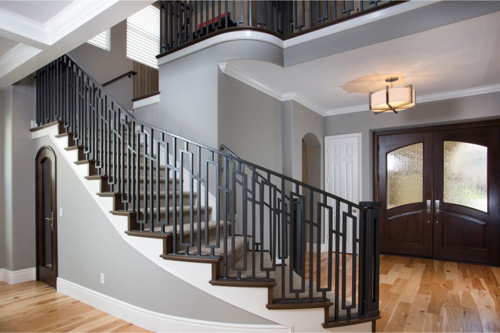 Design ideas for a large traditional wood curved staircase in San Diego with wood risers and feature lighting.