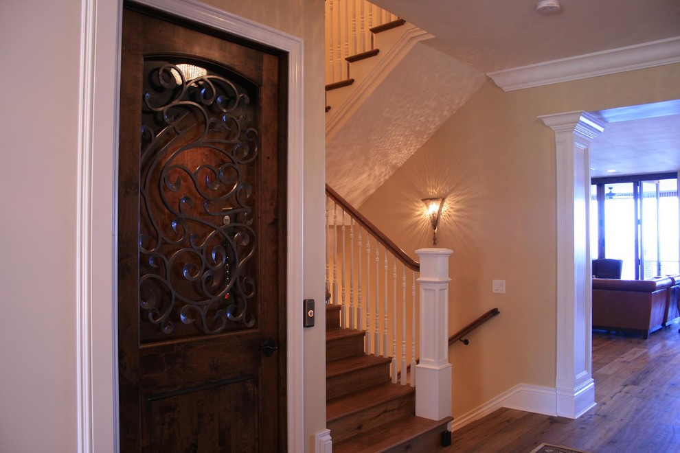 Design ideas for a large traditional wood u-shaped staircase in Tampa with wood risers.