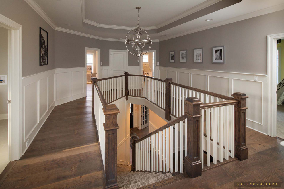 Small country carpeted curved wood railing staircase in Chicago.