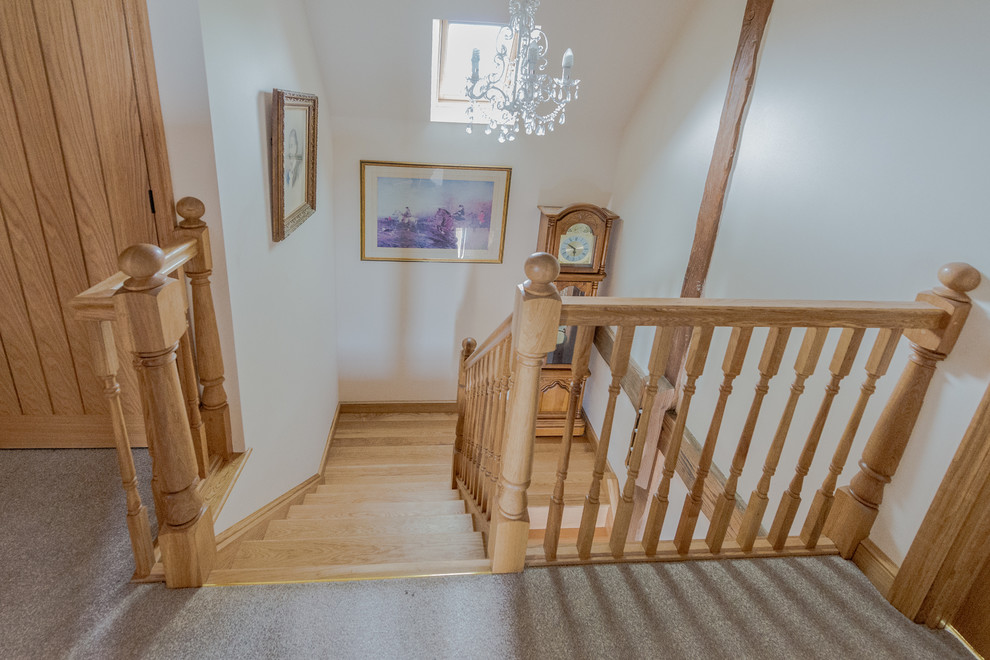 Photo of a small traditional wood u-shaped staircase in Cambridgeshire with wood risers.