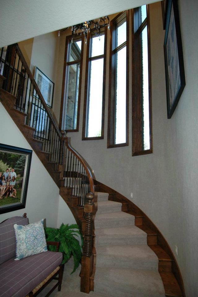 Inspiration for a large timeless carpeted curved staircase remodel in Salt Lake City with carpeted risers