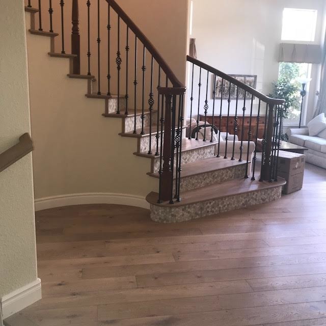 Inspiration for a large contemporary wooden curved mixed material railing staircase remodel in San Diego with tile risers