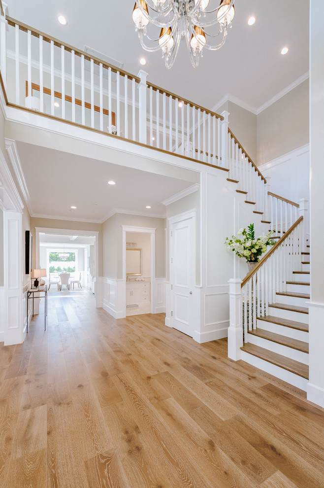 Medium sized traditional wood u-shaped wood railing staircase in Los Angeles with wood risers.