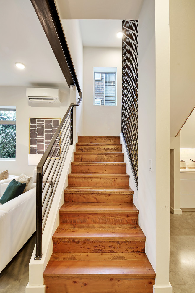 Inspiration for a medium sized industrial wood l-shaped metal railing staircase in Seattle with wood risers.