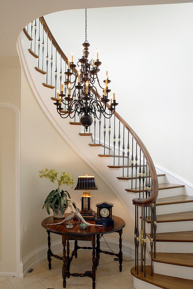 Photo of a classic wood curved mixed railing staircase spindle in Philadelphia with painted wood risers.
