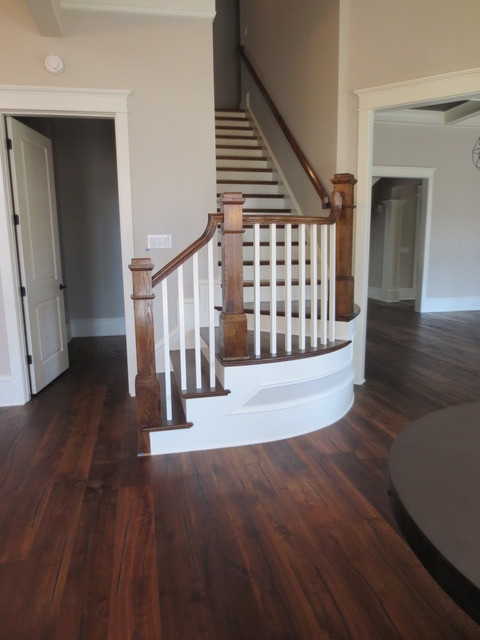 Medium sized classic wood curved staircase in Atlanta with painted wood risers.