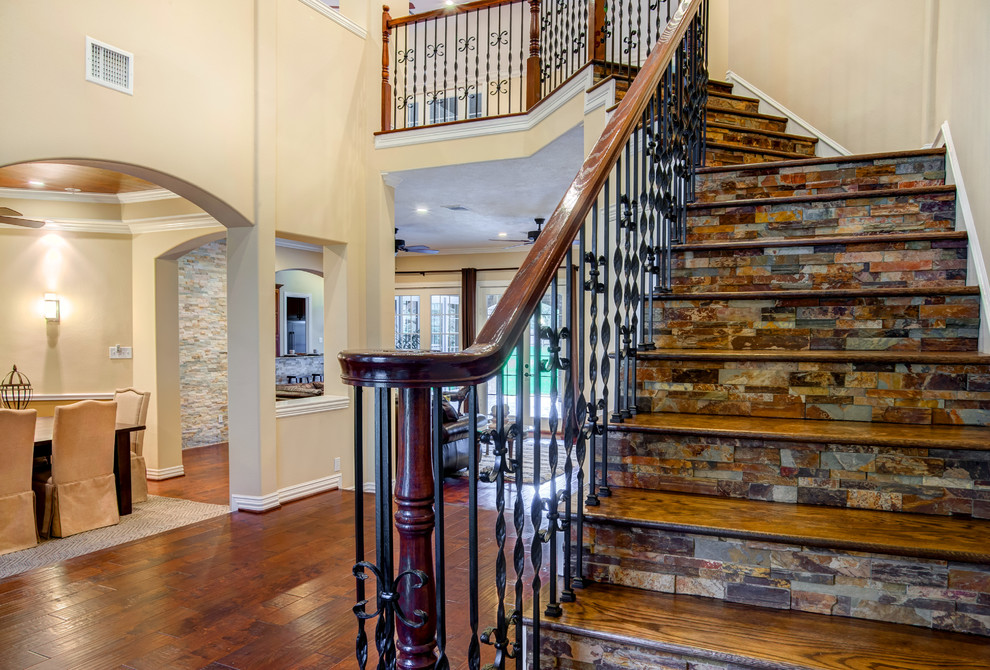 На фото: угловая лестница среднего размера в стиле неоклассика (современная классика) с деревянными ступенями и подступенками из плитки с