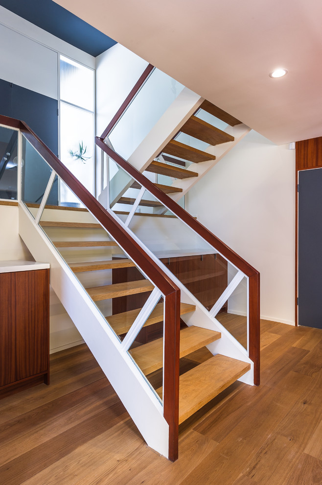 Large 1950s wooden u-shaped open staircase photo in Los Angeles